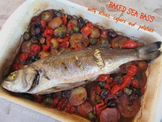 Baked sea bass with black olives, capers and potatoes